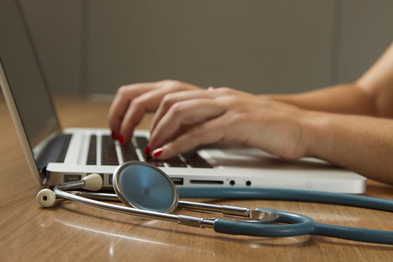 Clinician reviewing lab results on a laptop